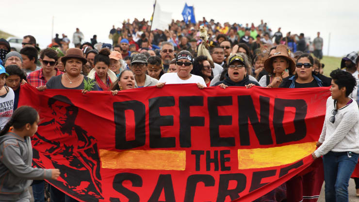 Native Americans march to a burial ground sacred site that was disturbed by bulldozers during building of the Dakota Access Pipeline (DAPL), near the encampment where hundreds of people have gathered to join the Standing Rock Sioux Tribe's protest of the oil pipeline, September 4, 2016 near Cannon Ball, North Dakota.