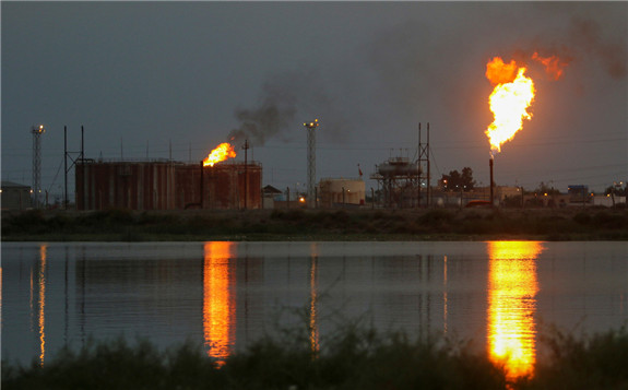 Flames emerge from flare stacks at Nahr Bin Umar oil field, north of Basra, Iraq, September 16, 2019.